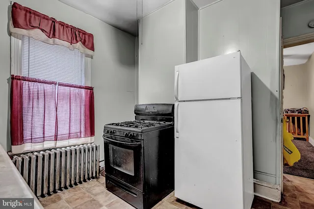 a kitchen with a stove and a refrigerator