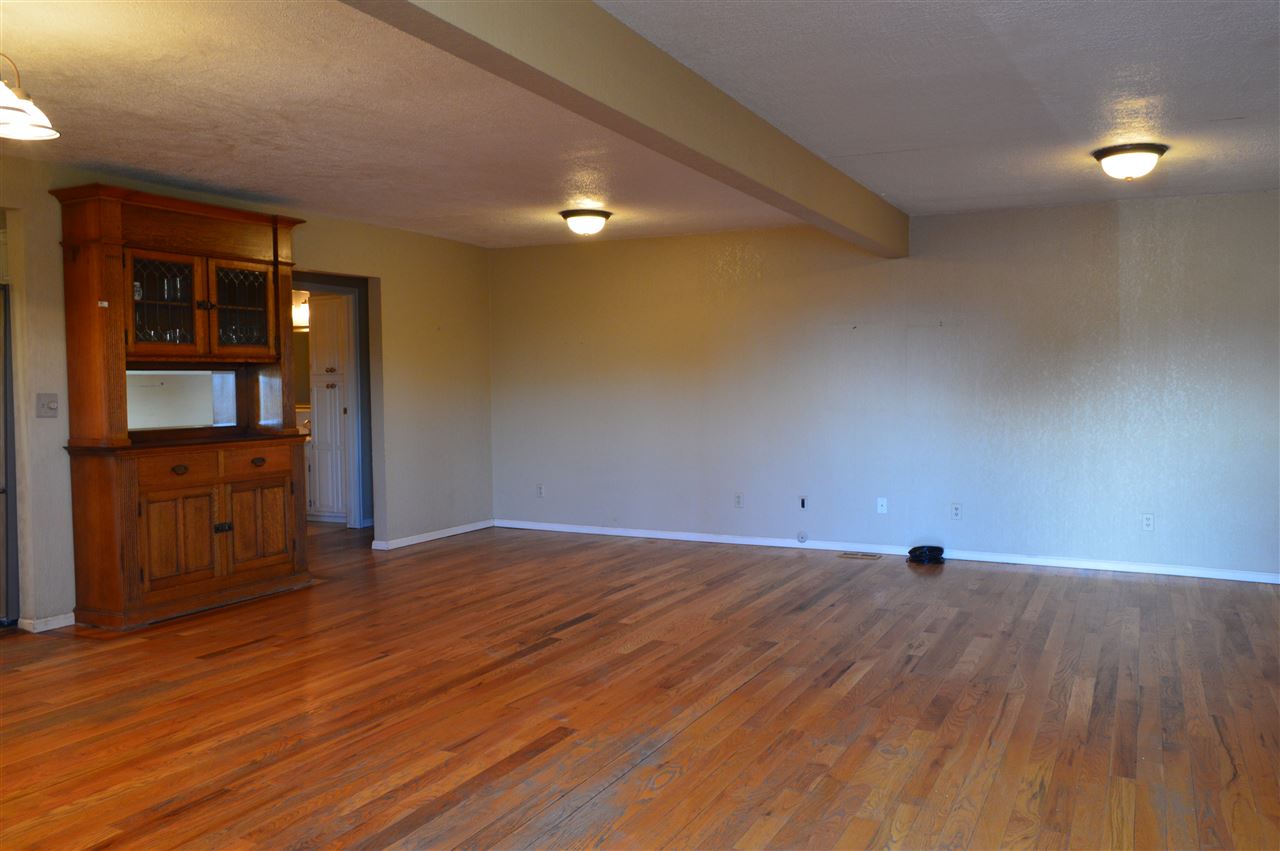 737 25 Road Grand Junction, CO 81505 - Photo 3 of 21 a view of an empty room with wooden floor and a window