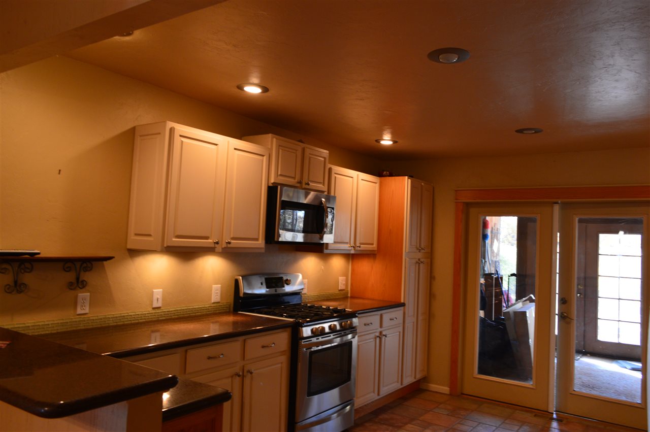 737 25 Road Grand Junction, CO 81505 - Photo 5 of 21 a kitchen with stainless steel appliances a stove a sink a microwave a refrigerator and cabinets
