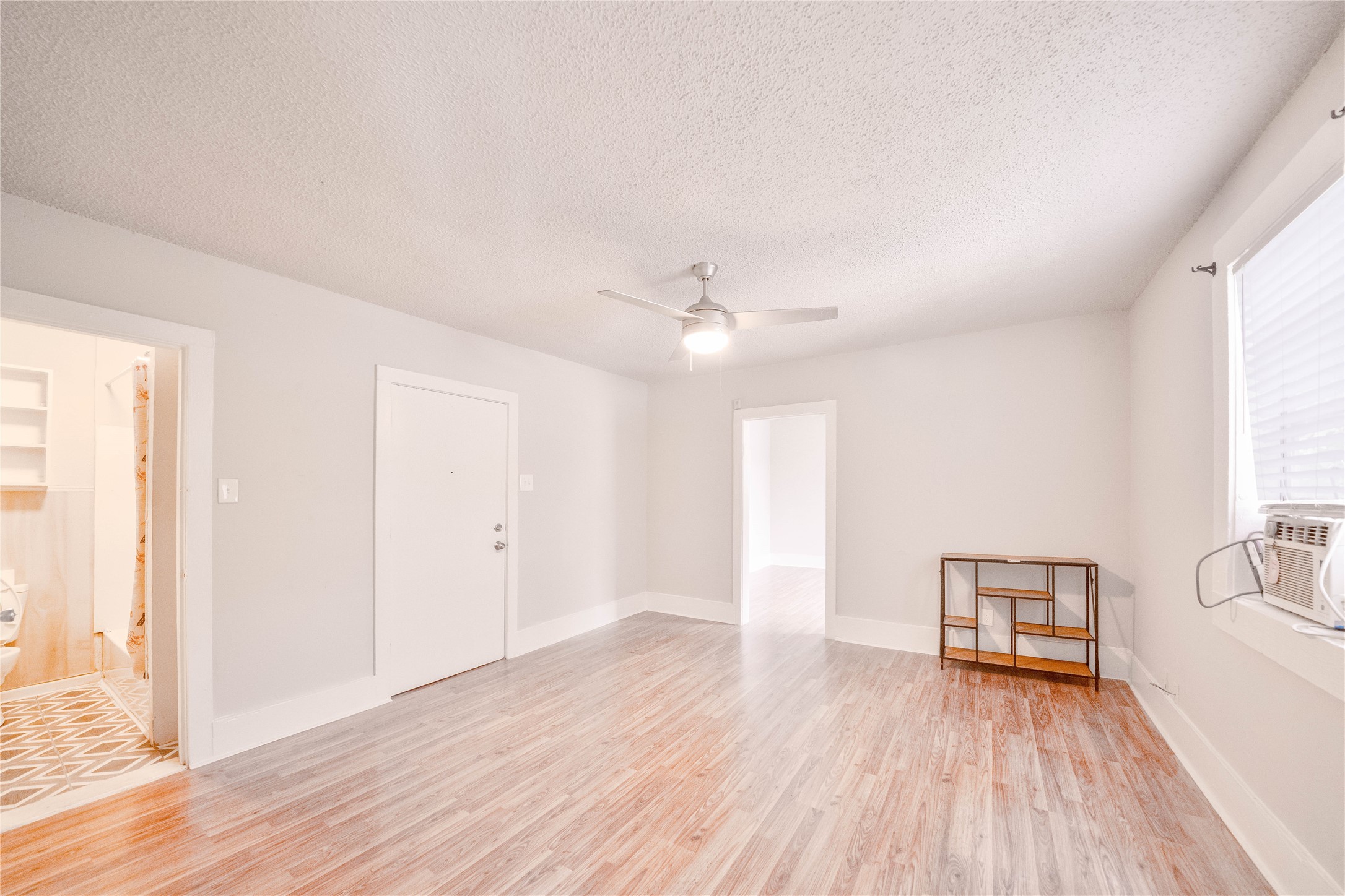 315 8th Avenue North, Unit 2 Texas City, TX 77590 - Photo 1 of 6 a view of a livingroom with wooden floor and a ceiling fan