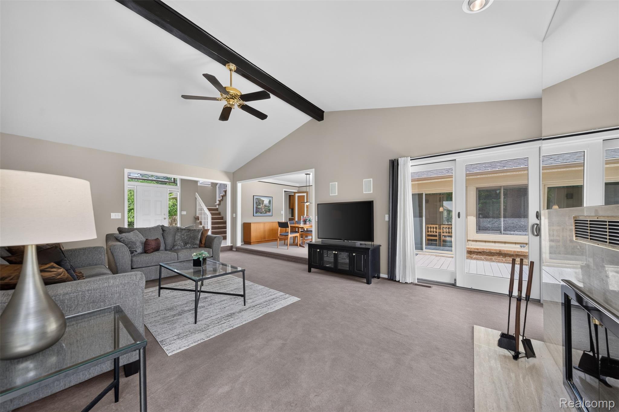 1236 Chaffer Drive Rochester, MI 48306 - Photo 8 of 76 Spacious living area featuring vaulted ceilings with exposed beams, a ceiling fan, and light gray carpeting