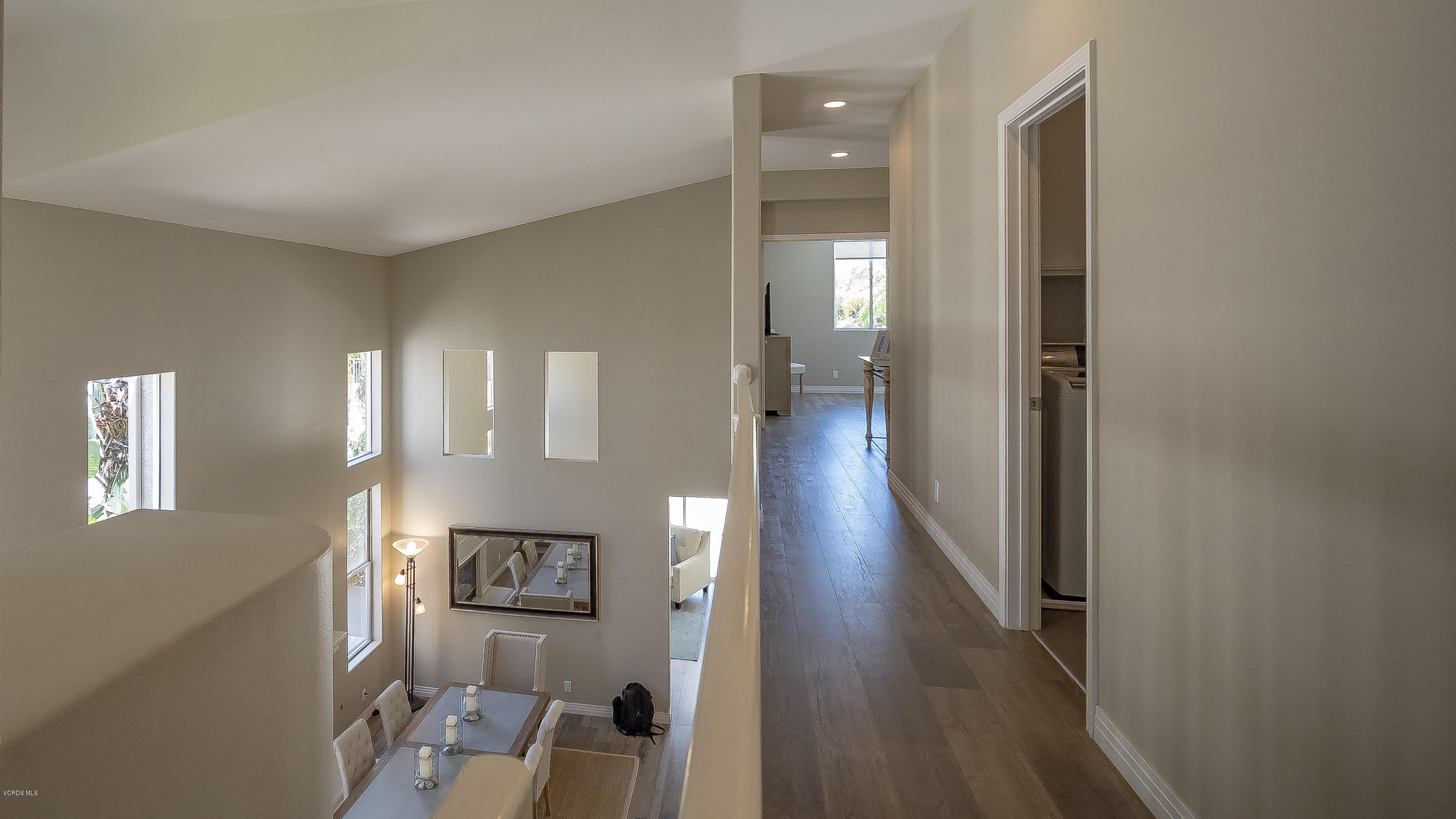 3944 Sunsetridge Road Moorpark, CA 93021 - Photo 11 of 25 a view of a hallway with wooden floor and livingroom with furniture