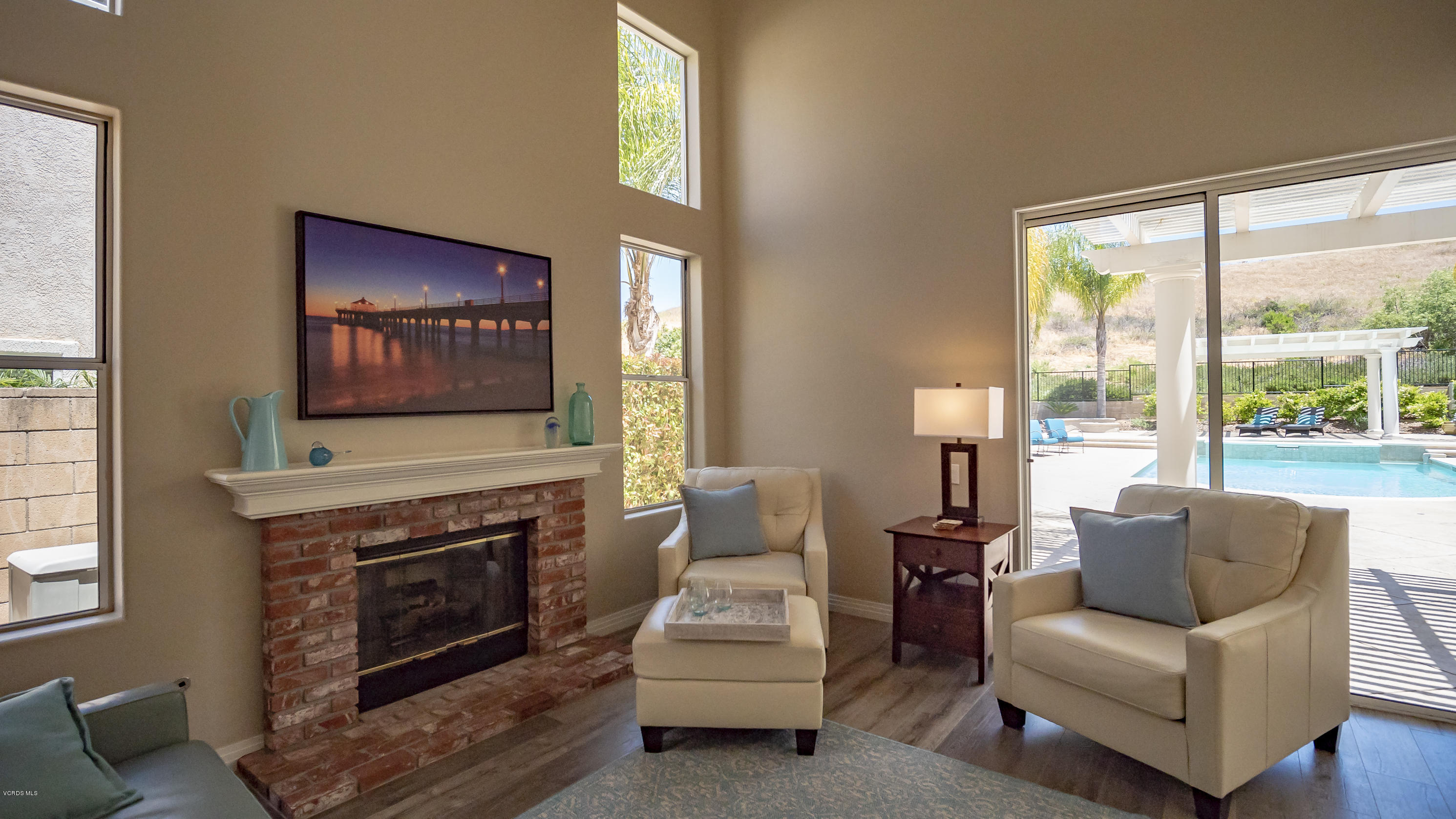 3944 Sunsetridge Road Moorpark, CA 93021 - Photo 6 of 25 a living room with furniture a fireplace and a flat screen tv