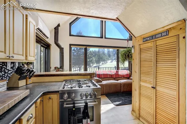a living room with furniture a flat screen tv and a walk in closet