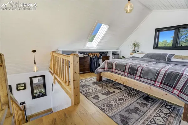 a bedroom with a large bed and a window