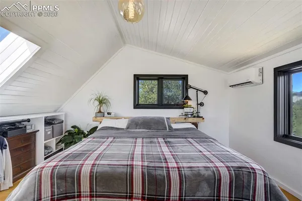 a bed sitting in a bedroom next to a window