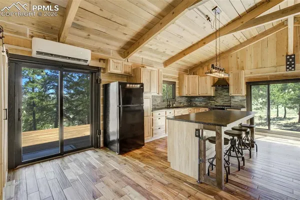 a kitchen with a sink a counter space appliances and cabinets