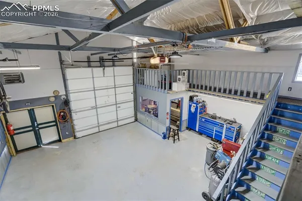 a large kitchen with stainless steel appliances kitchen island granite countertop a sink counter space cabinets and a stove