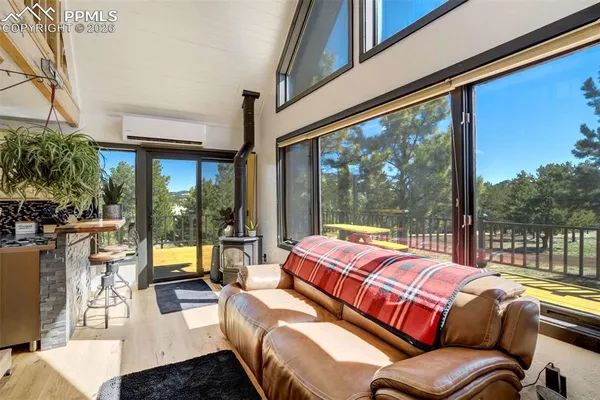 a view of living room kitchen with stainless steel appliances granite countertop cabinets and outdoor view