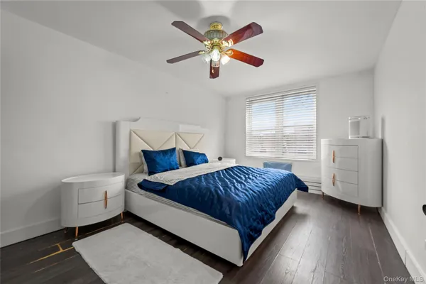 a spacious bedroom with a bed and window