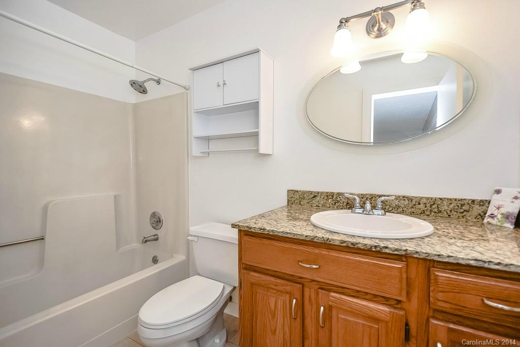 5064 Suwarrow Circle Tega Cay, SC 29708 - Photo 13 of 23 a bathroom with a granite countertop sink mirror toilet and bathtub