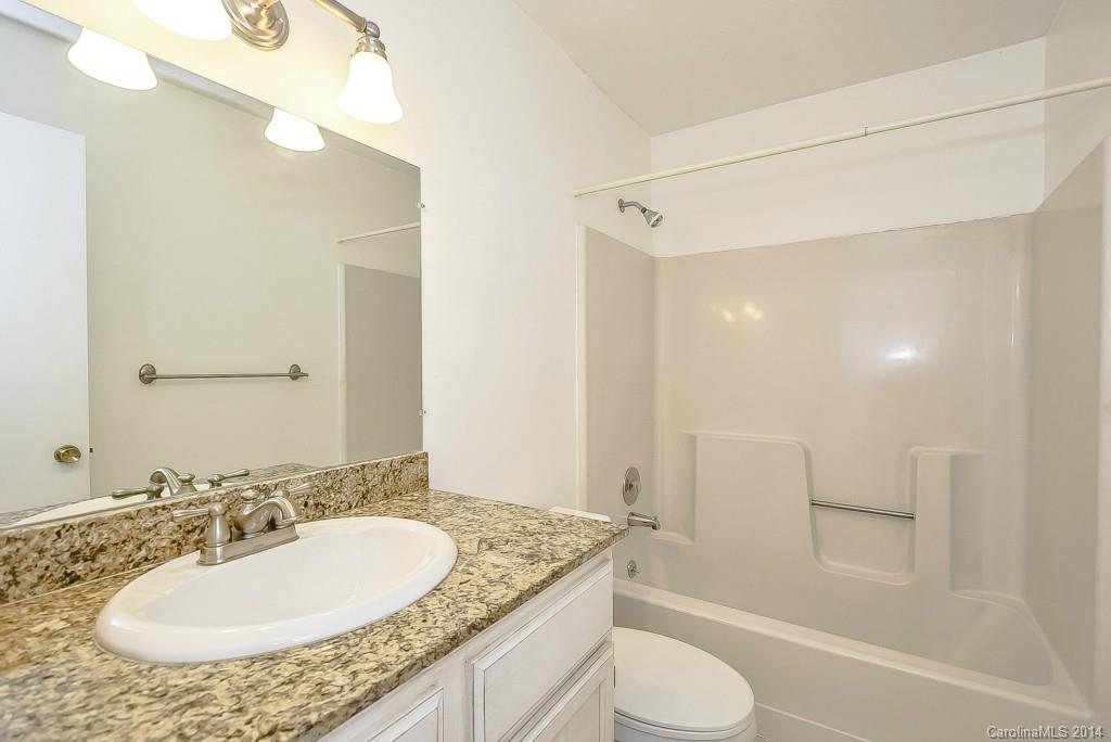 5064 Suwarrow Circle Tega Cay, SC 29708 - Photo 15 of 23 a bathroom with a granite countertop sink toilet and shower