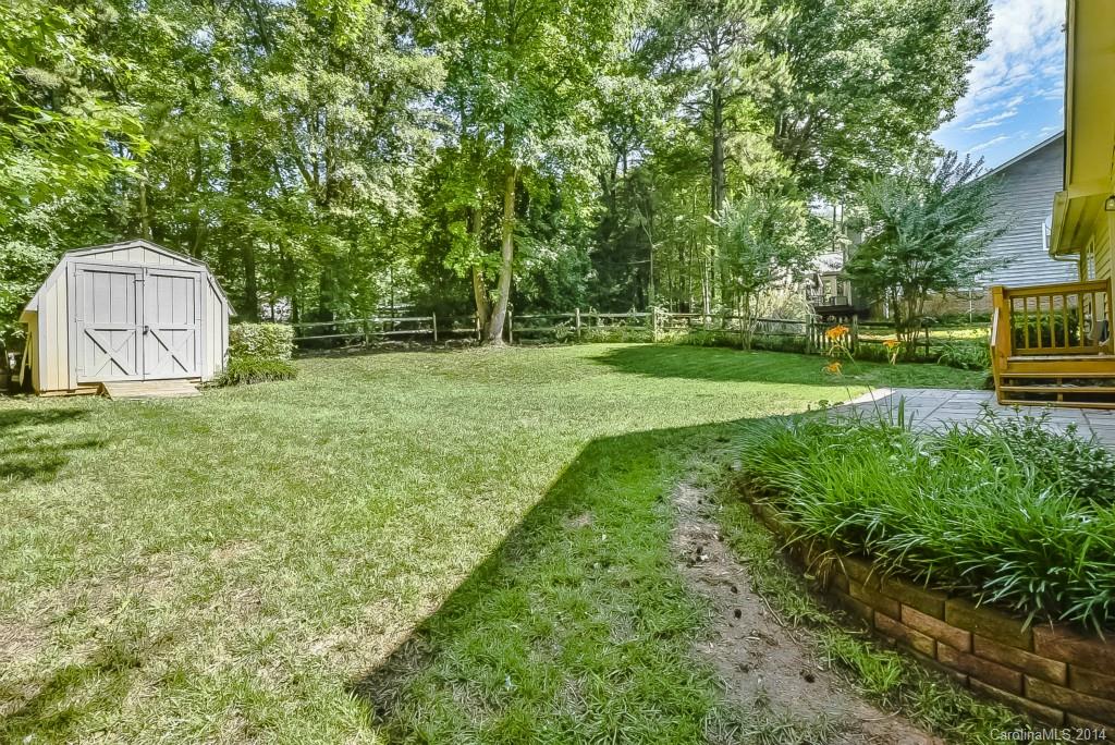 5064 Suwarrow Circle Tega Cay, SC 29708 - Photo 20 of 23 a view of a backyard with large trees