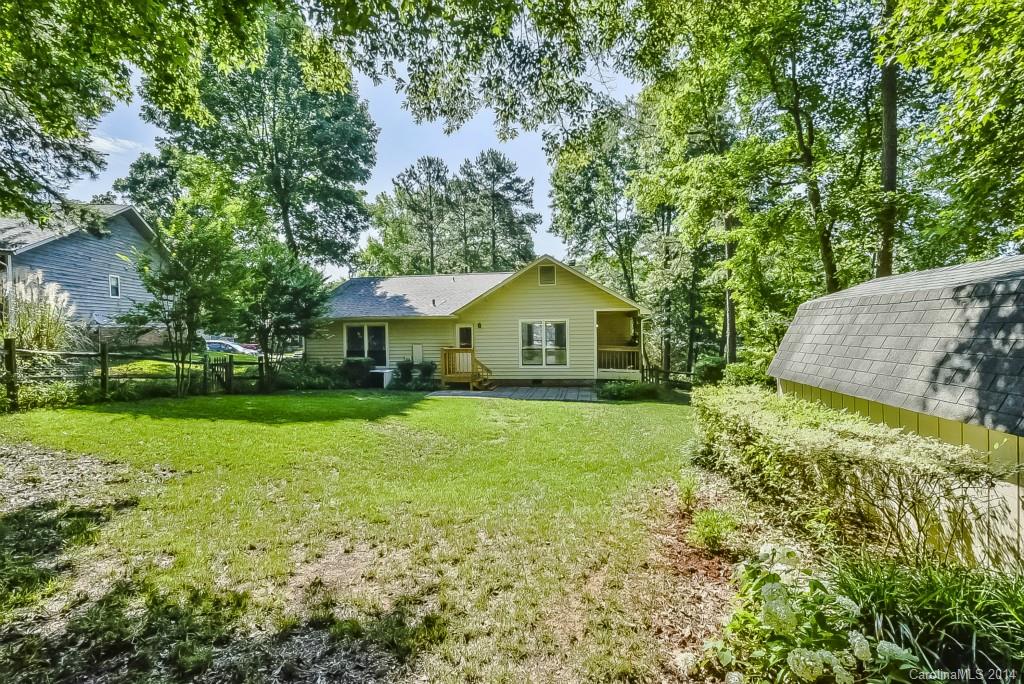 5064 Suwarrow Circle Tega Cay, SC 29708 - Photo 21 of 23 a backyard of a house with plants and large trees