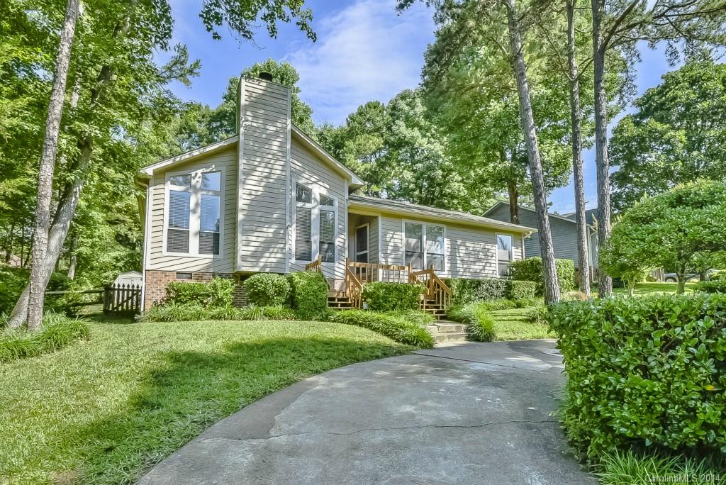 5064 Suwarrow Circle Tega Cay, SC 29708 - Photo 22 of 23 a front view of a house with a yard and potted plants