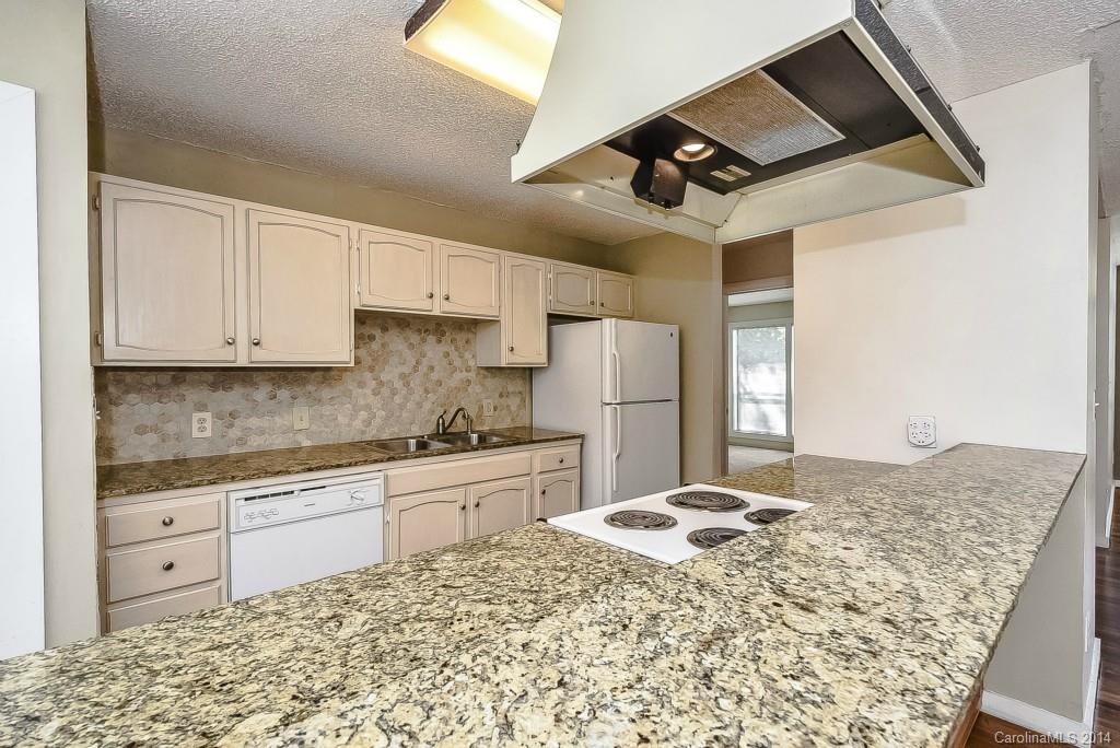 5064 Suwarrow Circle Tega Cay, SC 29708 - Photo 8 of 23 a kitchen with stainless steel appliances kitchen island granite countertop a sink stove and refrigerator