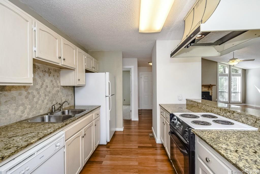 5064 Suwarrow Circle Tega Cay, SC 29708 - Photo 9 of 23 a kitchen with stainless steel appliances granite countertop a sink stove and refrigerator