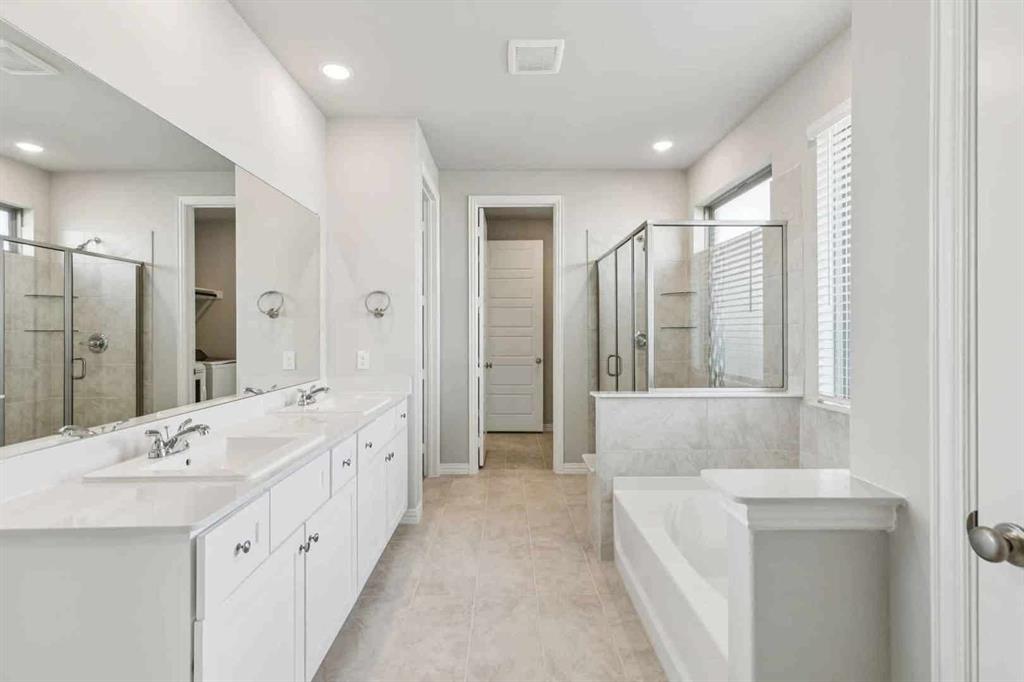 2339 Butler Avenue Fate, TX 75087 - Photo 16 of 35 a spacious bathroom with a double vanity sink mirror and double