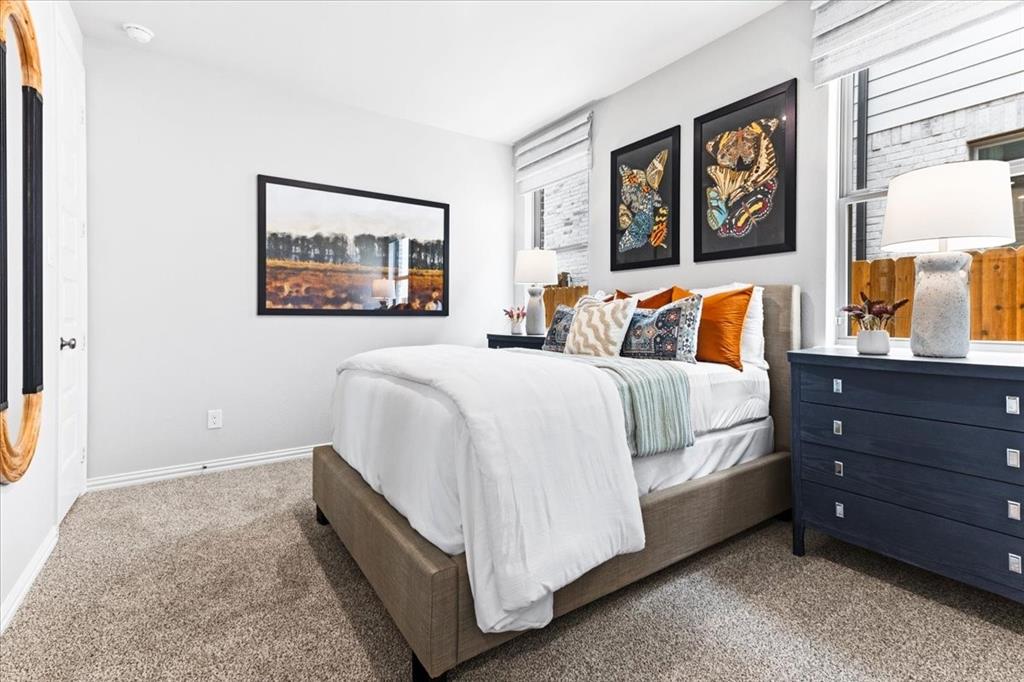 2339 Butler Avenue Fate, TX 75087 - Photo 20 of 35 a bedroom with a bed and night stand