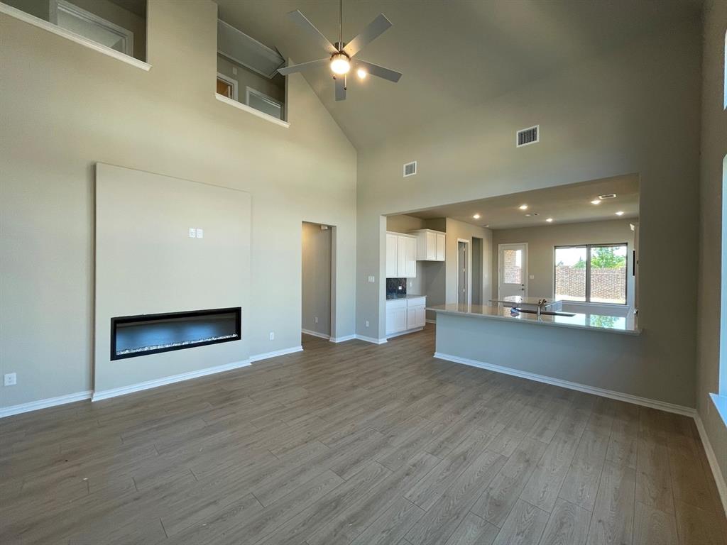 2339 Butler Avenue Fate, TX 75087 - Photo 24 of 35 an empty room with wooden floor and windows