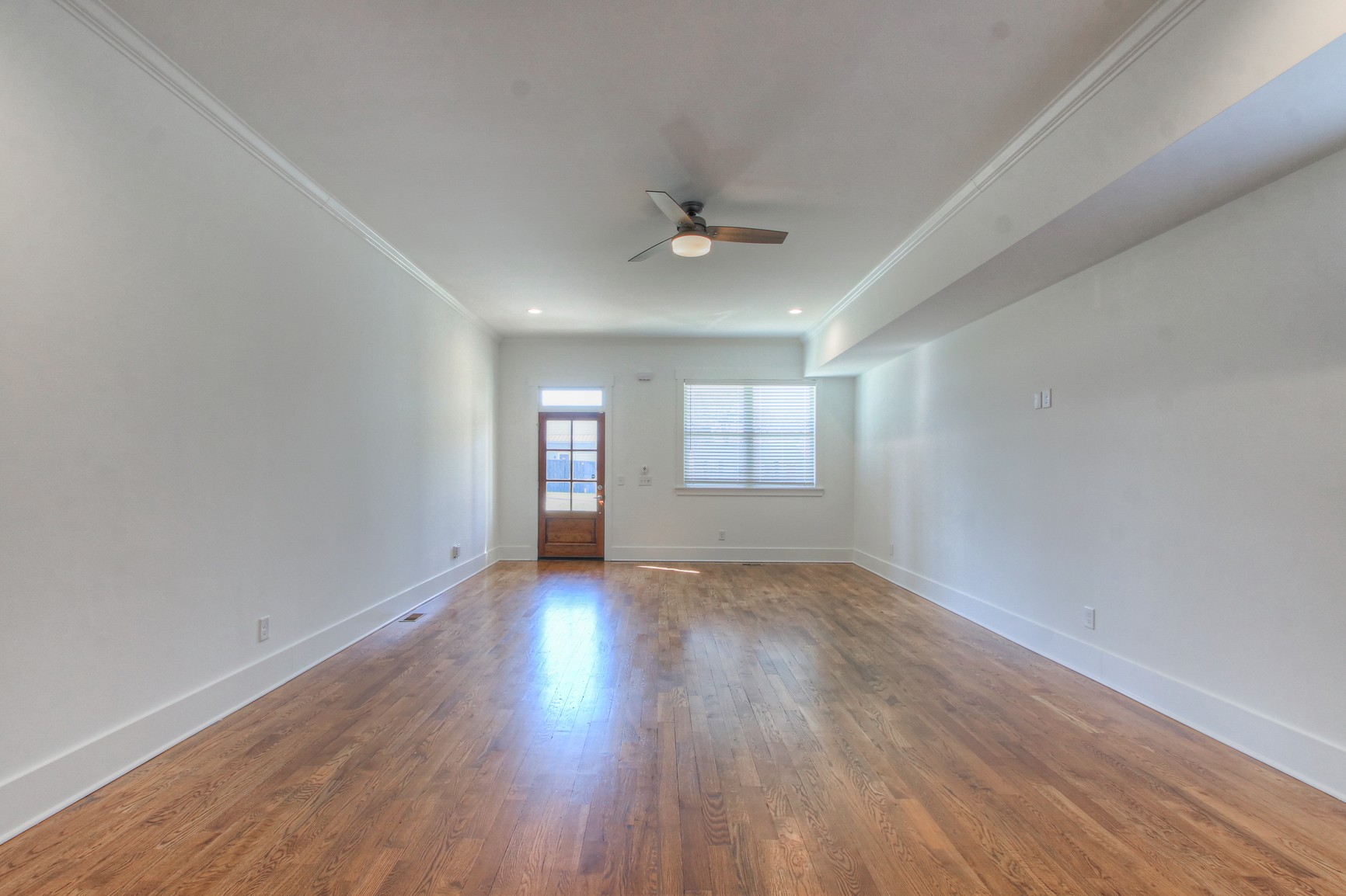 341 Edwin Street, Unit A Nashville, TN 37207 - Photo 5 of 37 an empty room with wooden floor ceiling fan and windows