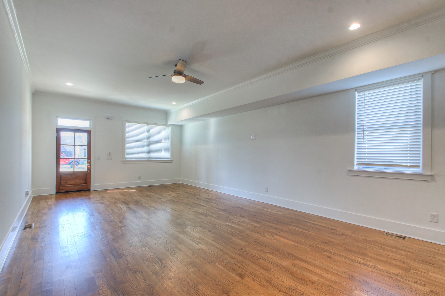 341 Edwin Street, Unit A Nashville, TN 37207 - Photo 6 of 37 an empty room with wooden floor and windows