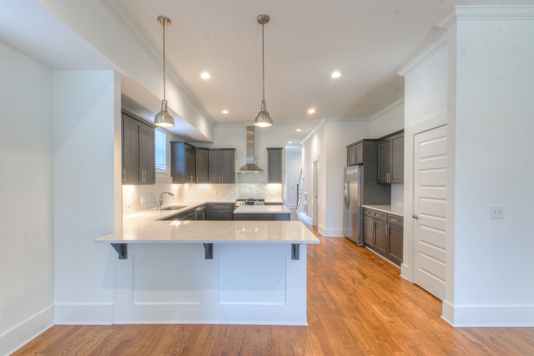 341 Edwin Street, Unit A Nashville, TN 37207 - Photo 8 of 37 a large kitchen with stainless steel appliances kitchen island a large counter top and wooden floors