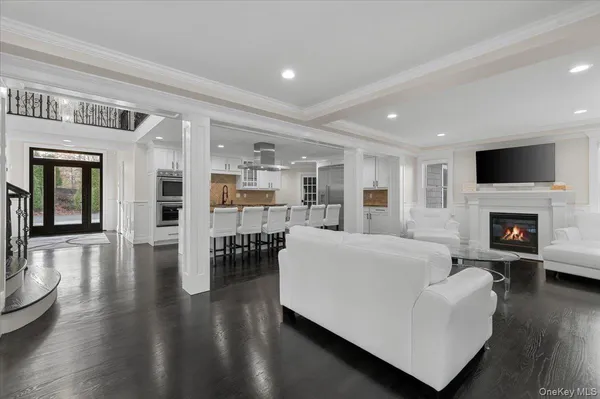 a living room with furniture wooden floor and a fireplace