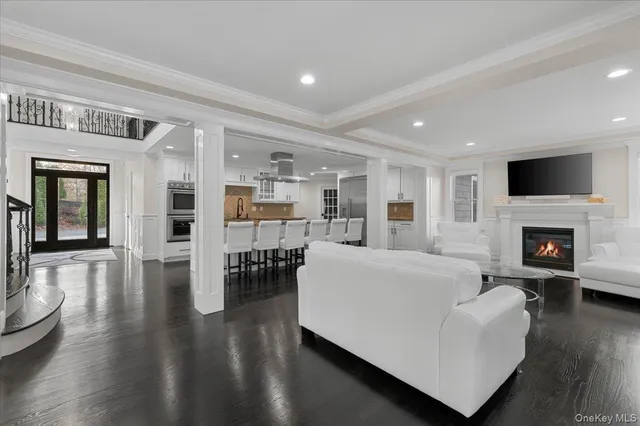 a living room with furniture wooden floor and a fireplace