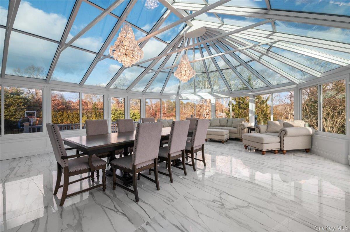 19 West Tiana Road Hampton Bays, NY 11946 - Photo 15 of 50 a view of a patio with table and chairs under an umbrella