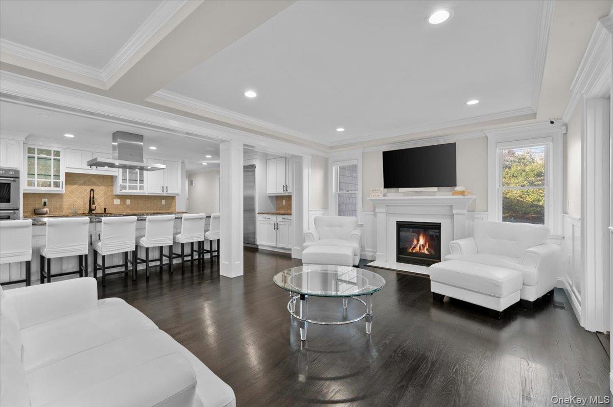 19 West Tiana Road Hampton Bays, NY 11946 - Photo 16 of 50 a living room with furniture a fireplace and a flat screen tv