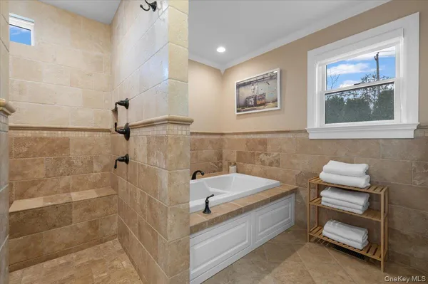 a spacious bathroom with a tub and shower