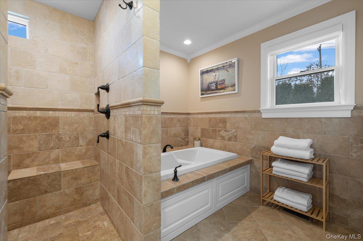 19 West Tiana Road Hampton Bays, NY 11946 - Photo 19 of 50 a spacious bathroom with a tub and shower