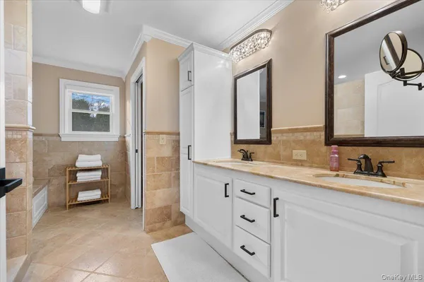 a bathroom with a double vanity sink a mirror and a