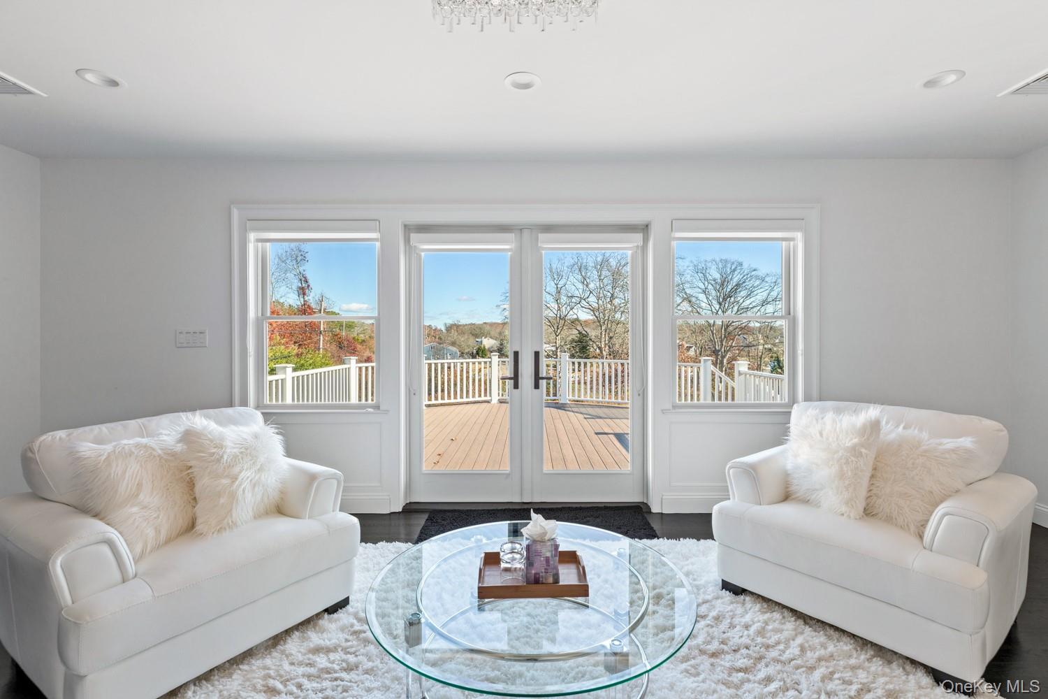 19 West Tiana Road Hampton Bays, NY 11946 - Photo 24 of 50 a living room with furniture and a large window
