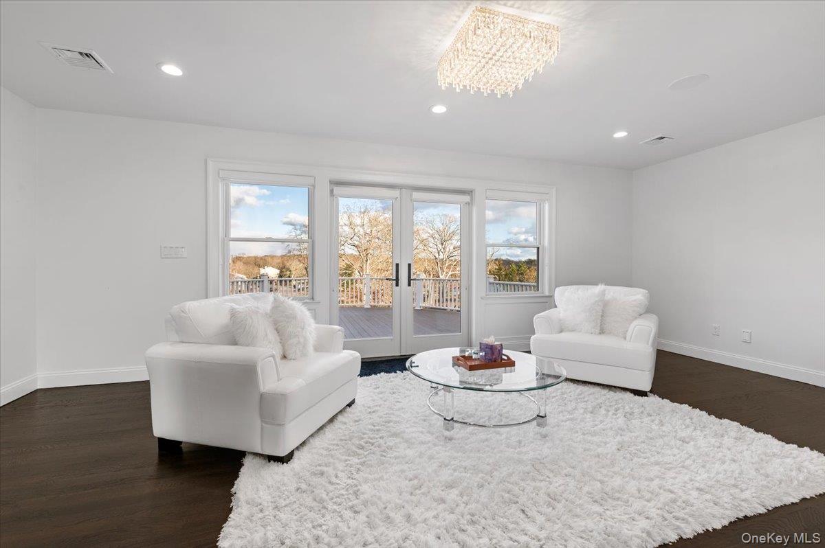 19 West Tiana Road Hampton Bays, NY 11946 - Photo 25 of 50 a living room with furniture and a wooden floor