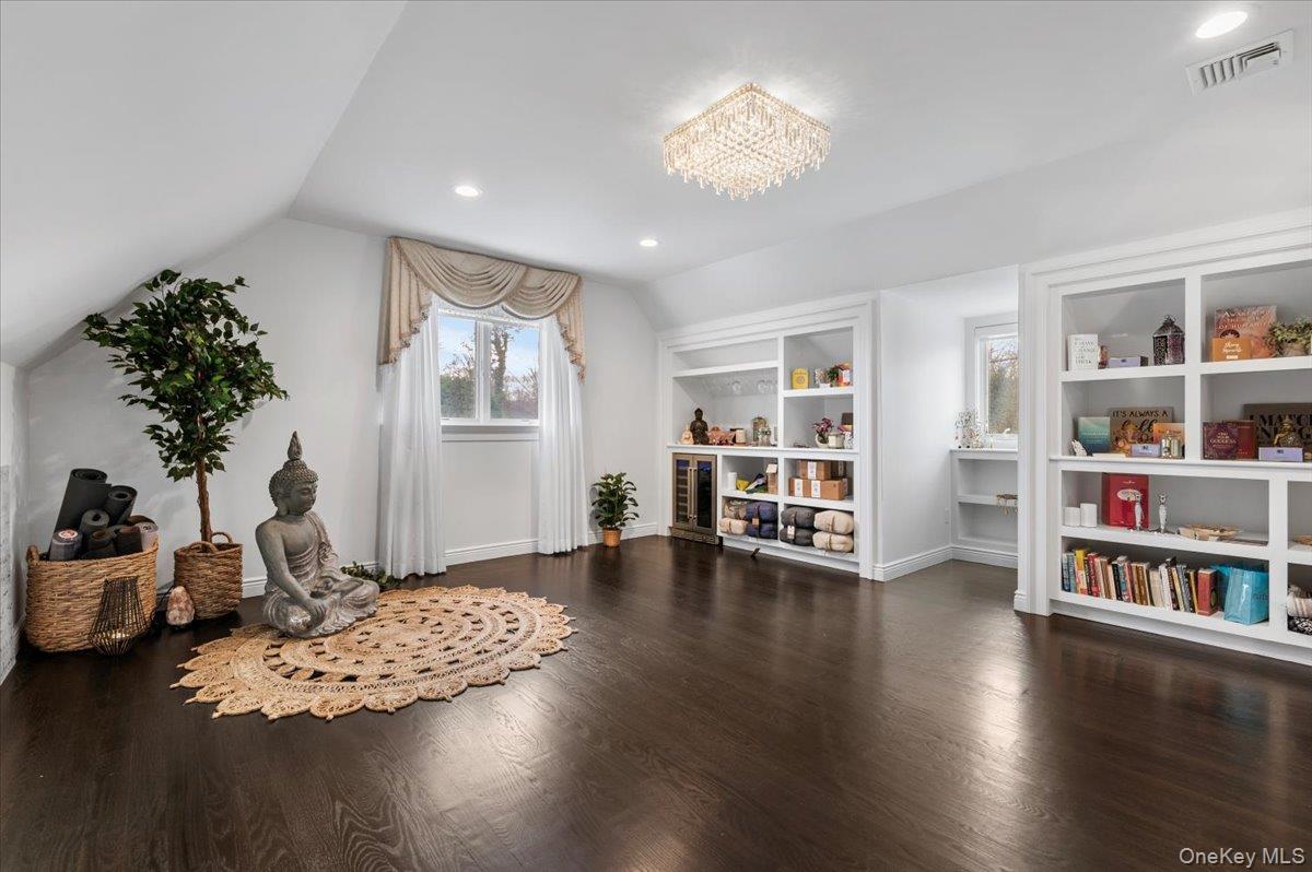 19 West Tiana Road Hampton Bays, NY 11946 - Photo 37 of 50 a living room with furniture and a book shelf