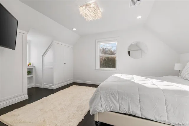 a bathroom with a granite countertop bathtub shower sink vanity and toilet