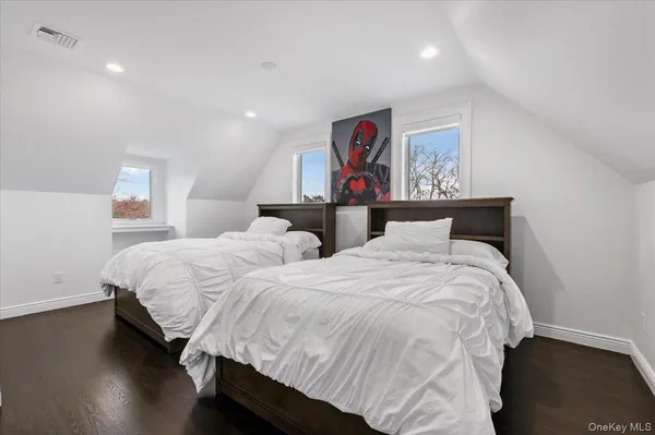 a bathroom with a double vanity sink a mirror and a shower