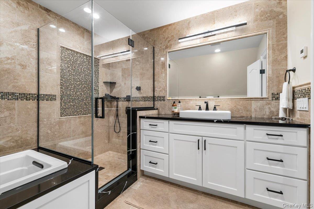 19 West Tiana Road Hampton Bays, NY 11946 - Photo 45 of 50 a bathroom with a double vanity sink a mirror and a shower