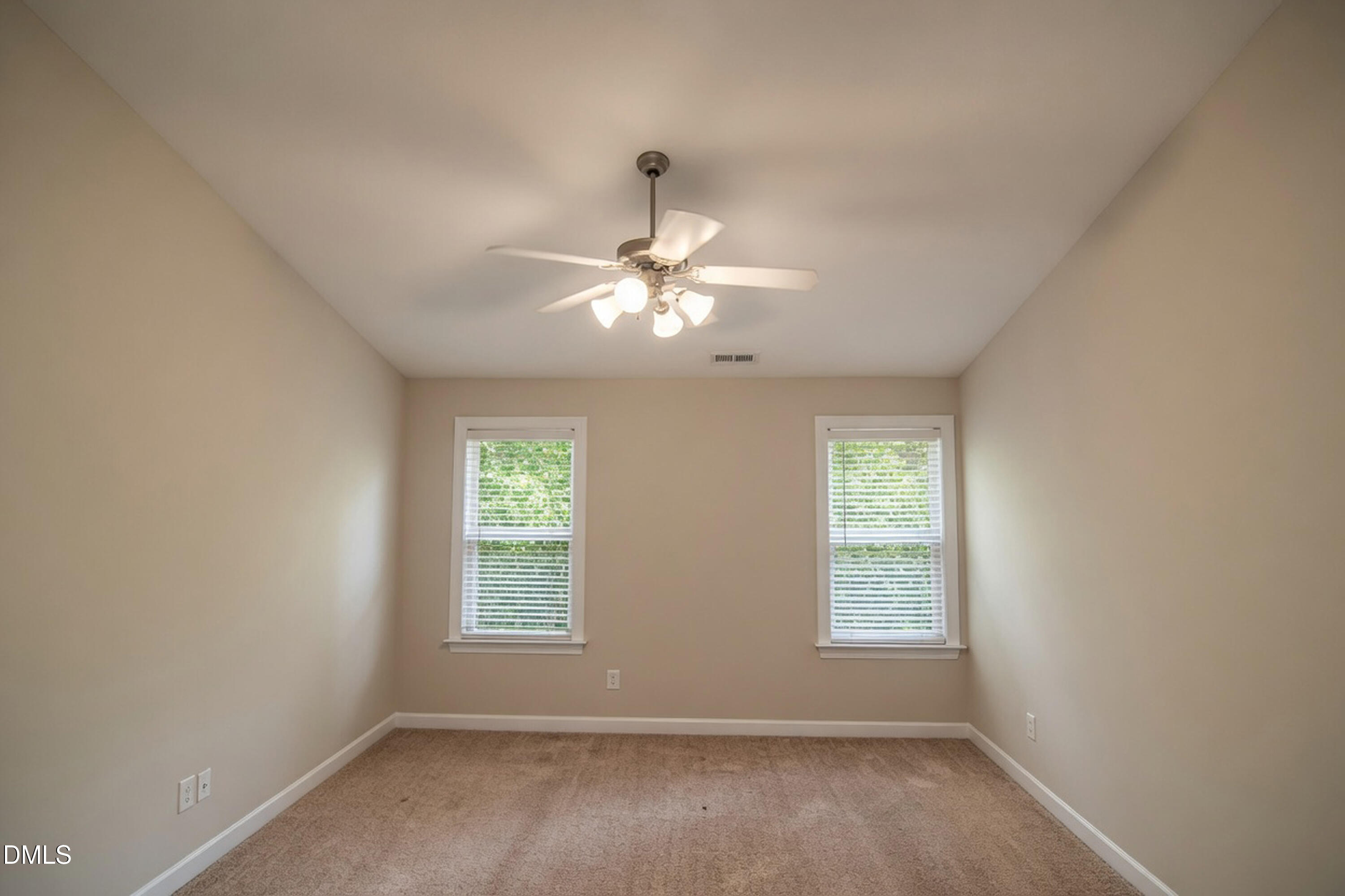 4809 Landover Pine Place Raleigh, NC 27616 - Photo 7 of 14 an empty room with windows and fan