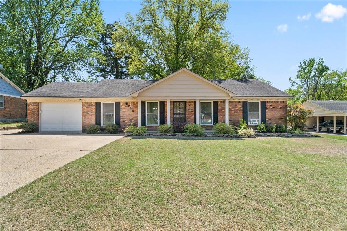6315 Bardstown Road Bartlett, TN 38134 - Photo 1 of 31 Ranch-style house featuring covered porch, brick siding, an attached garage, driveway, and a front yard