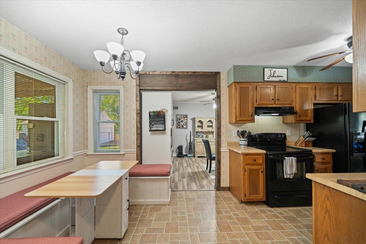 6315 Bardstown Road Bartlett, TN 38134 - Photo 14 of 31 Kitchen featuring a ceiling fan, black appliances, wood finish cabinets, light countertops, and wallpapered walls