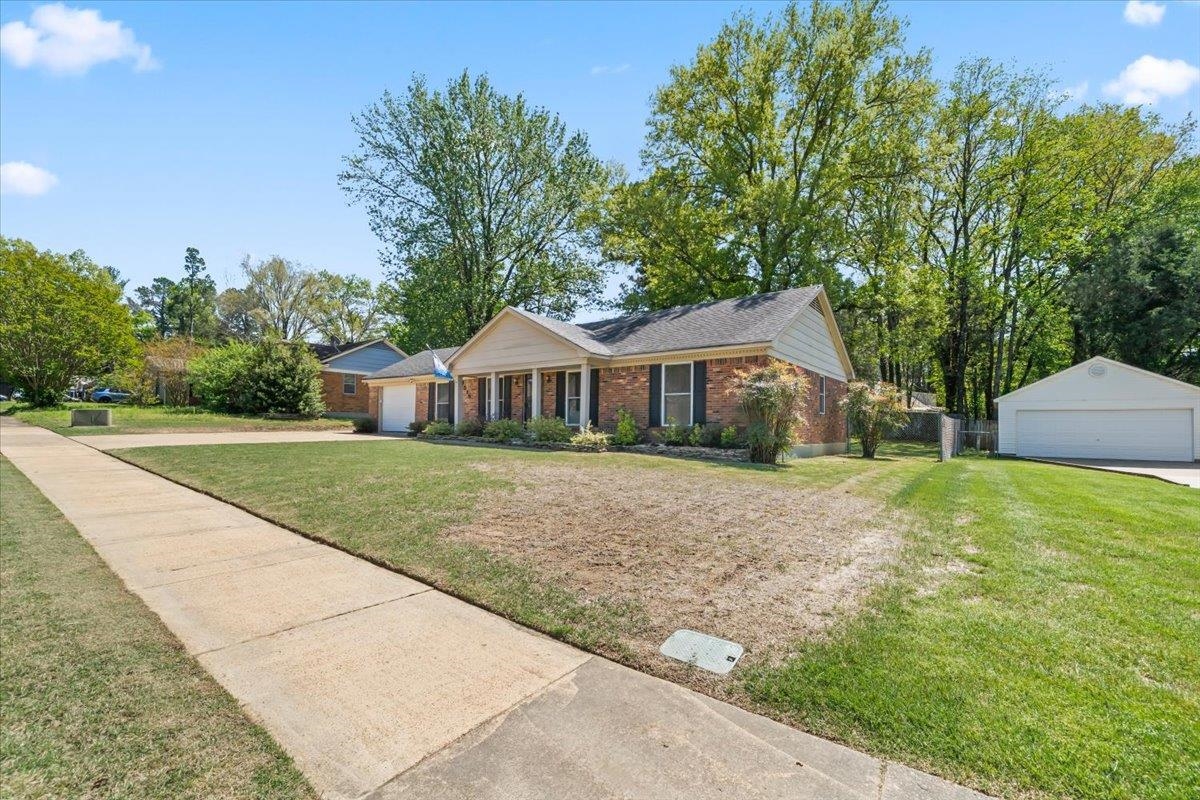 6315 Bardstown Road Bartlett, TN 38134 - Photo 2 of 31 Single story home featuring a front lawn, an outdoor structure, brick siding, and a detached garage