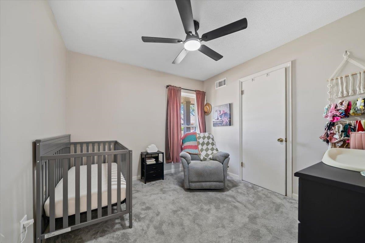 6315 Bardstown Road Bartlett, TN 38134 - Photo 21 of 31 Bedroom featuring a crib, light carpet, and ceiling fan