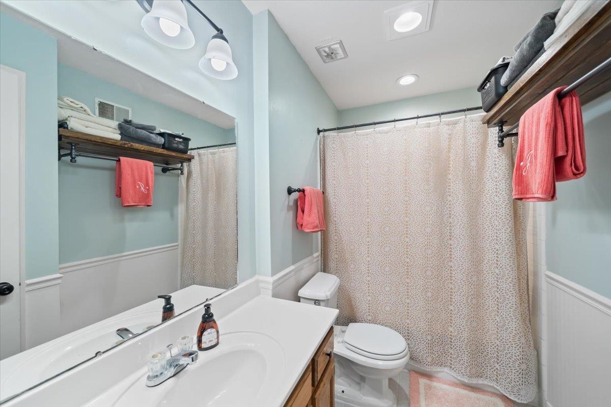 6315 Bardstown Road Bartlett, TN 38134 - Photo 22 of 31 Full bathroom with vanity, a shower with shower curtain, and wainscoting