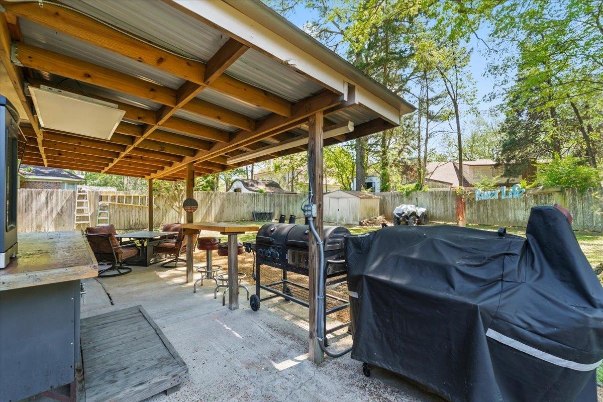 6315 Bardstown Road Bartlett, TN 38134 - Photo 24 of 31 Fenced backyard with grilling area, a storage shed, a patio area, and outdoor dining space