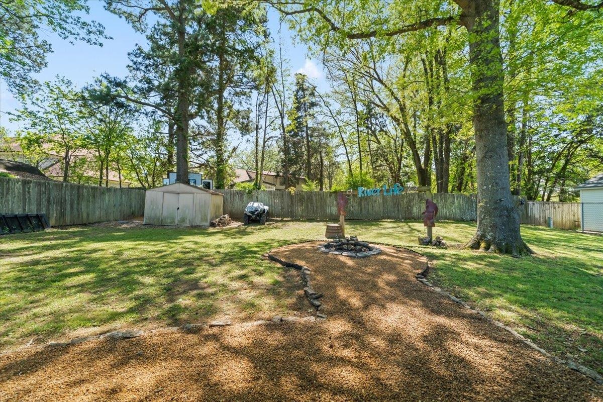 6315 Bardstown Road Bartlett, TN 38134 - Photo 25 of 31 Fenced backyard with a fire pit and a storage unit
