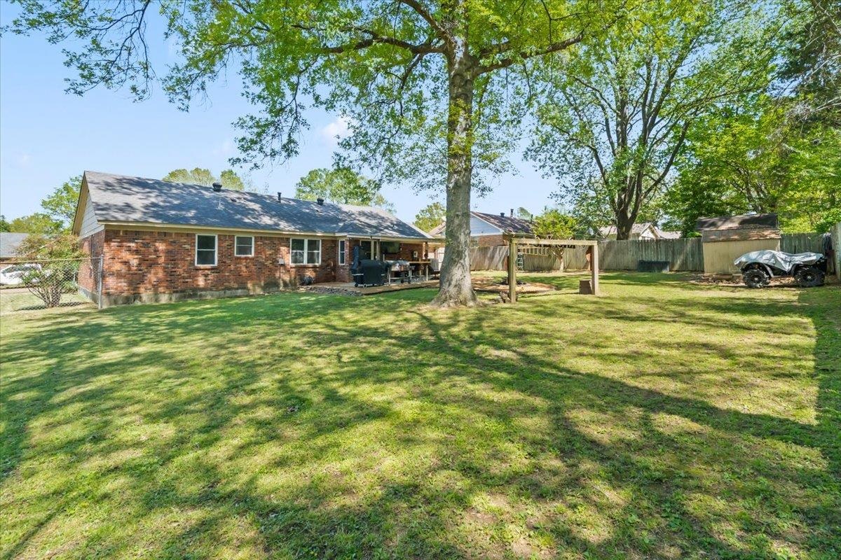 6315 Bardstown Road Bartlett, TN 38134 - Photo 28 of 31 Rear view of property with a fenced backyard, a patio, and brick siding