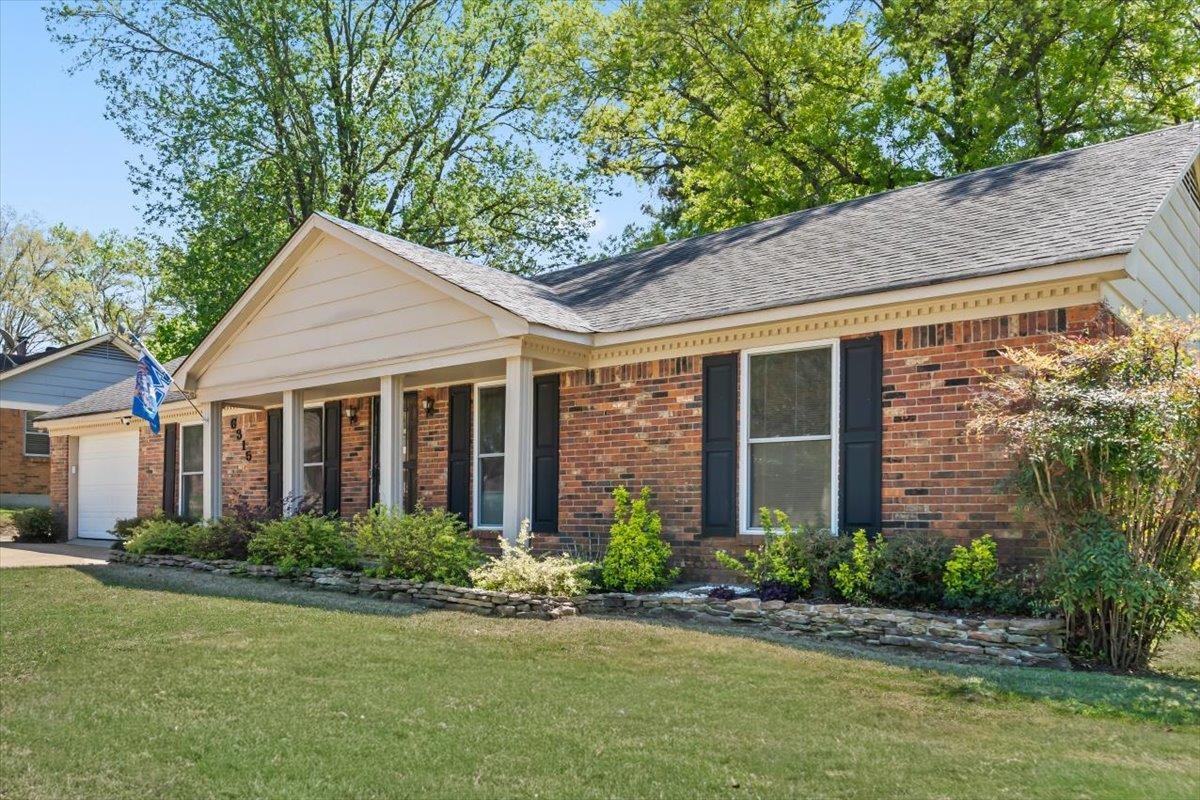 6315 Bardstown Road Bartlett, TN 38134 - Photo 3 of 31 View of front of property featuring a front lawn, a shingled roof, a porch, and brick siding